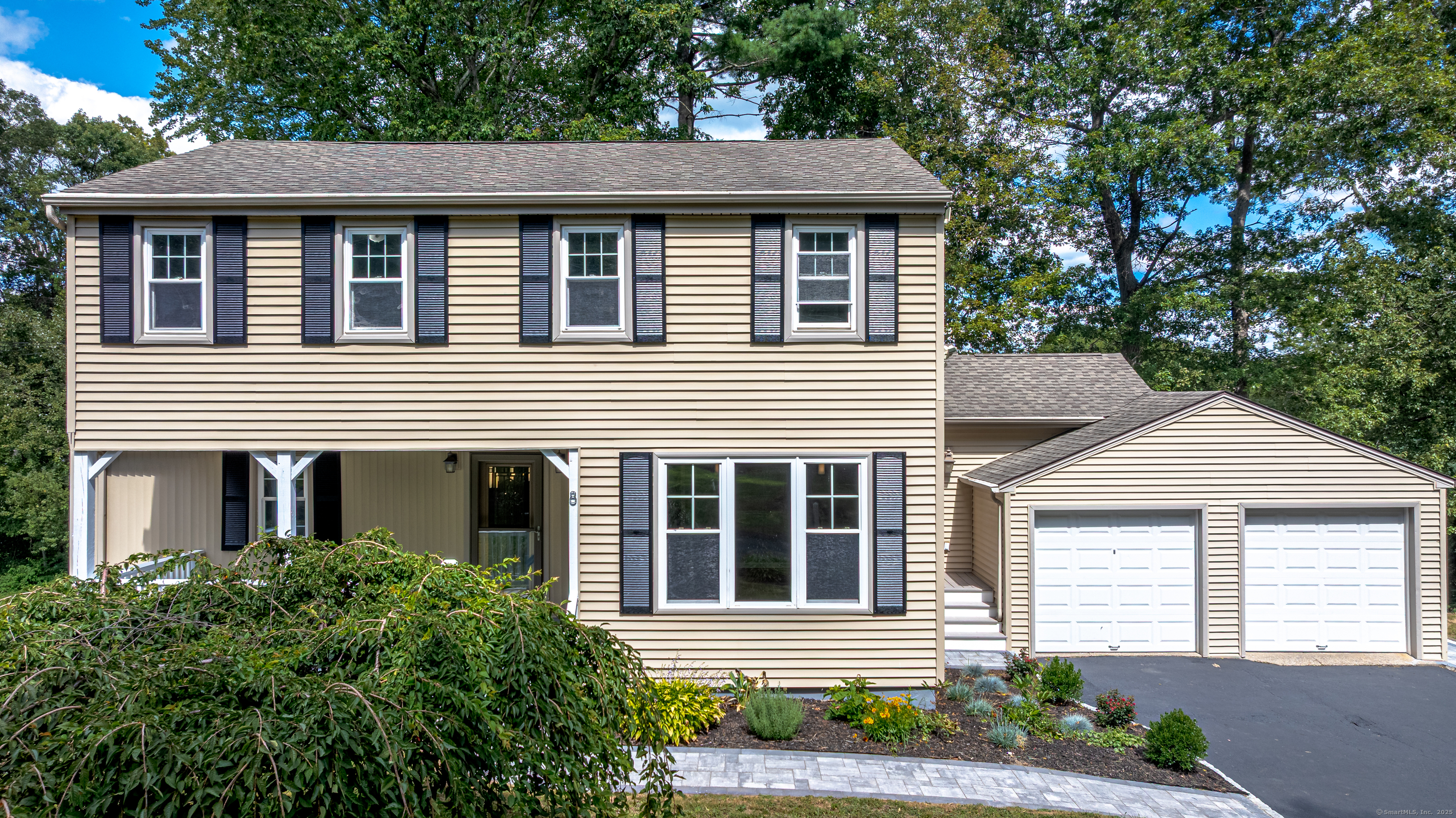 a front view of a house with a yard and outdoor seating