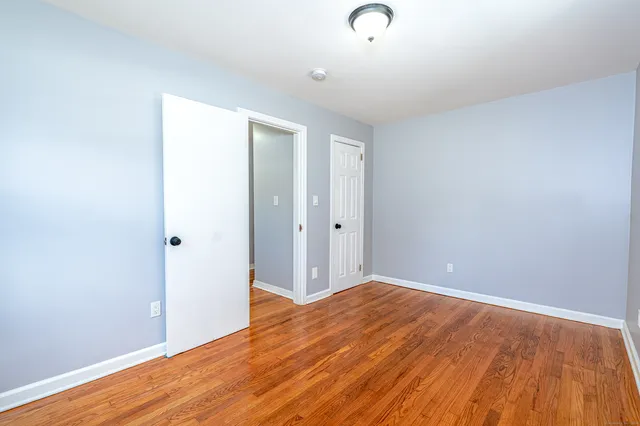 a view of room with wooden floor