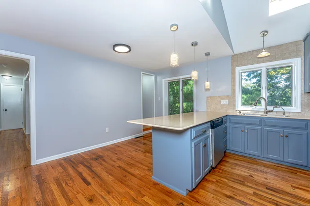 a kitchen with wooden floors and sink