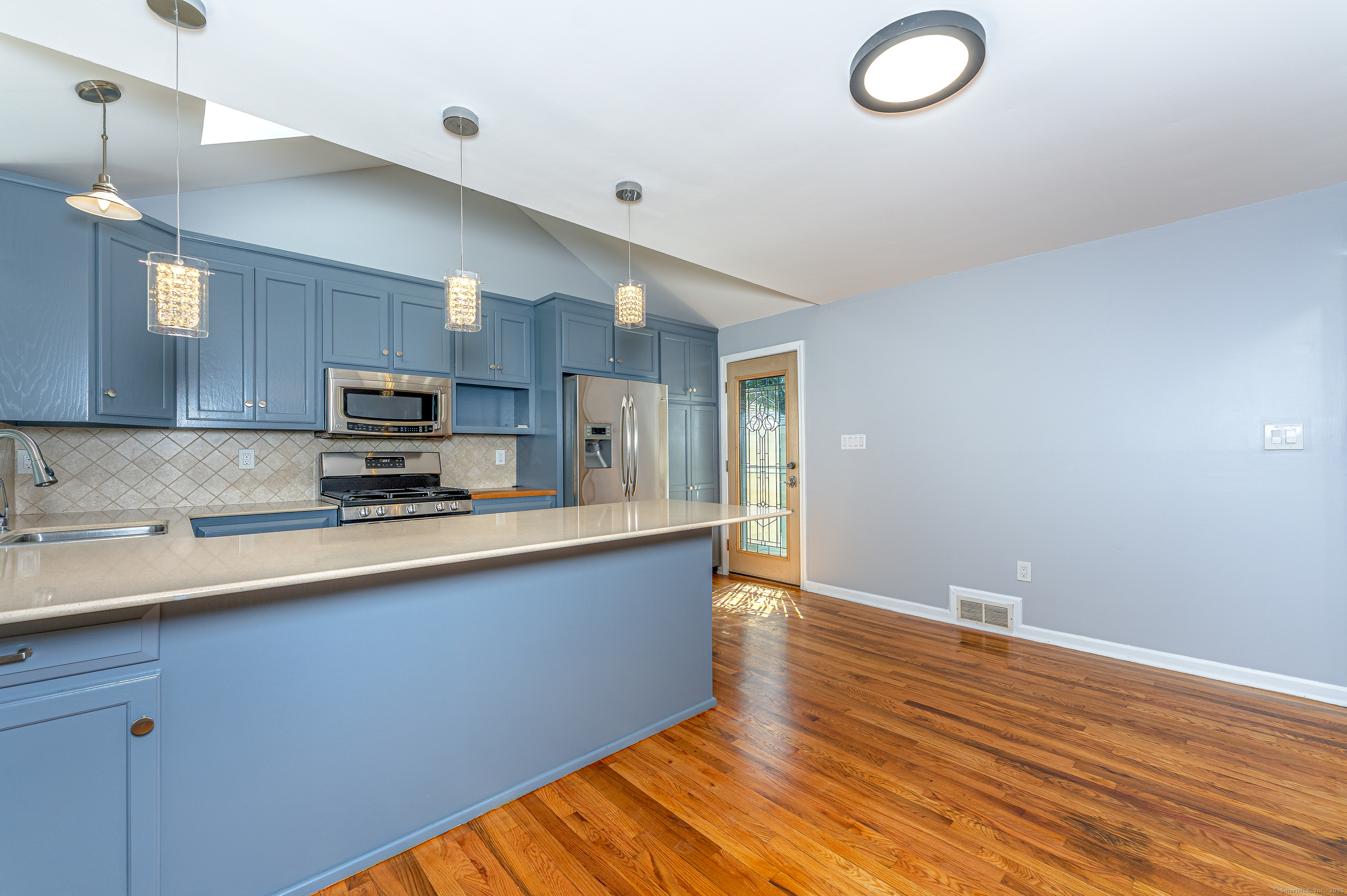 8 Ranslow Drive Wolcott, CT 06716 - Photo 18 of 31 a large kitchen with stainless steel appliances granite countertop a sink and cabinets with wooden floor