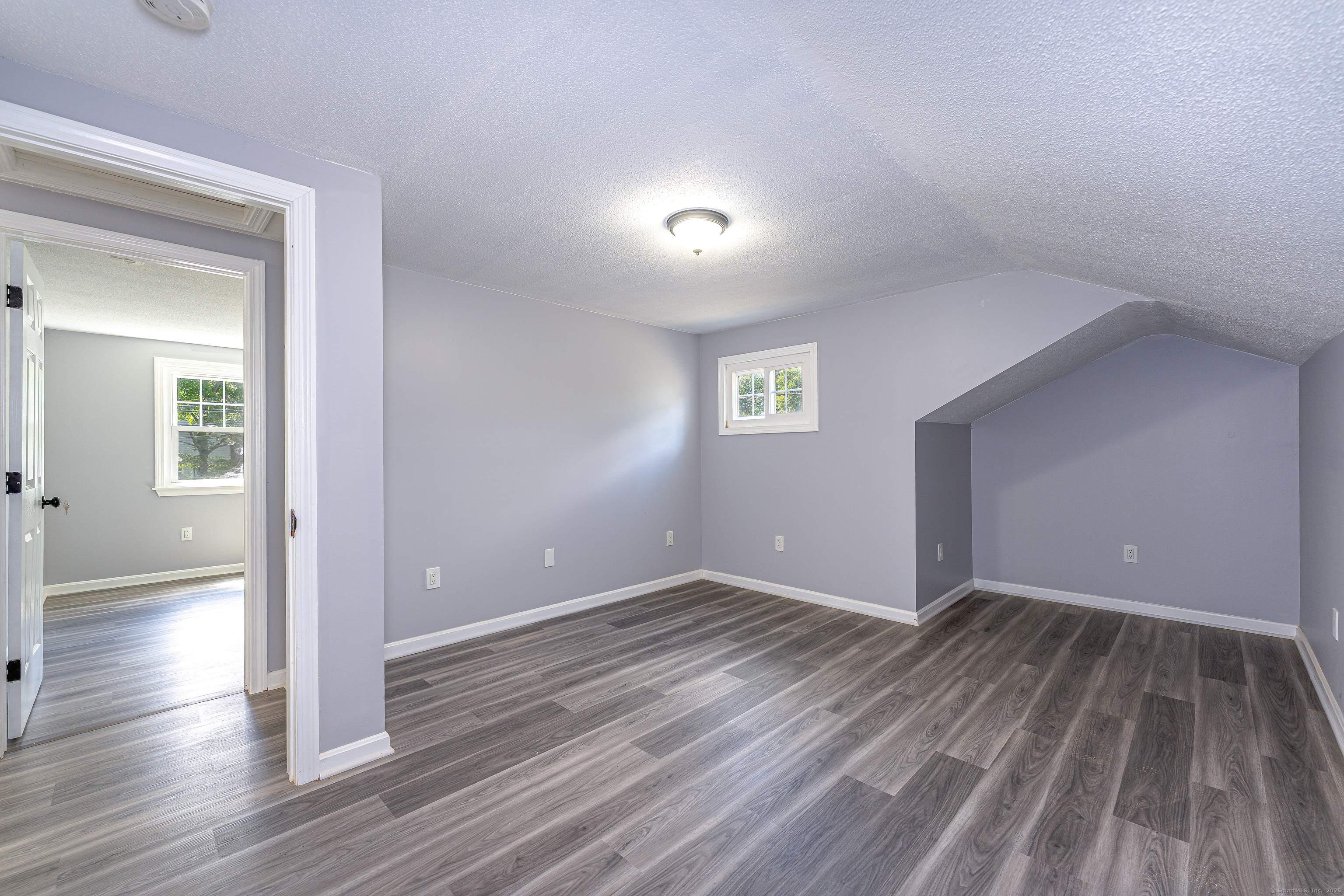 8 Ranslow Drive Wolcott, CT 06716 - Photo 24 of 31 an empty room with wooden floor and windows