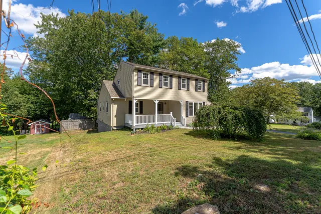 a view of a house with a yard porch and sitting area