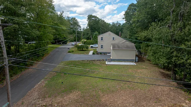 an aerial view of a house with a yard