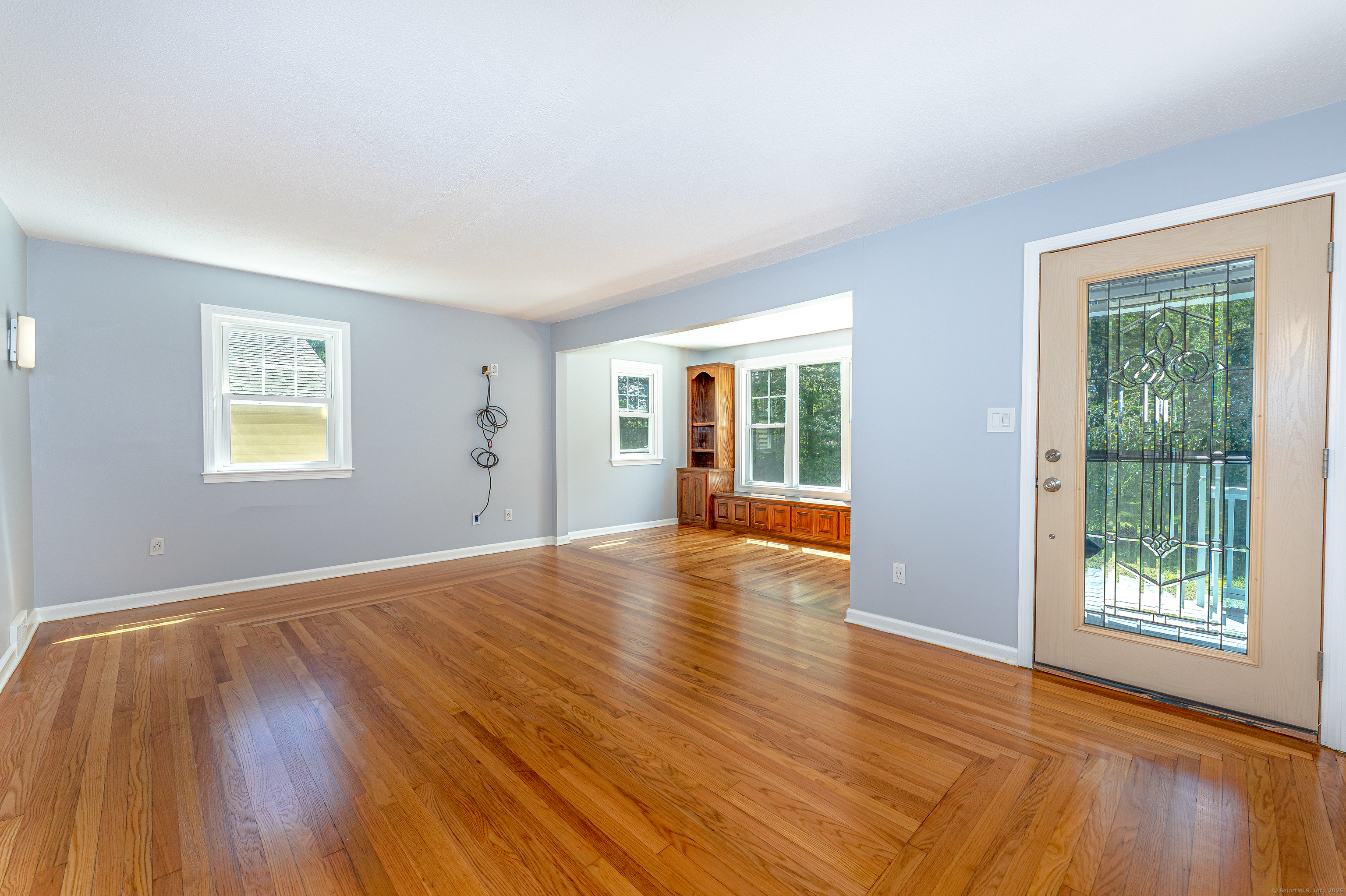 8 Ranslow Drive Wolcott, CT 06716 - Photo 7 of 31 a view of an empty room with wooden floor and a window