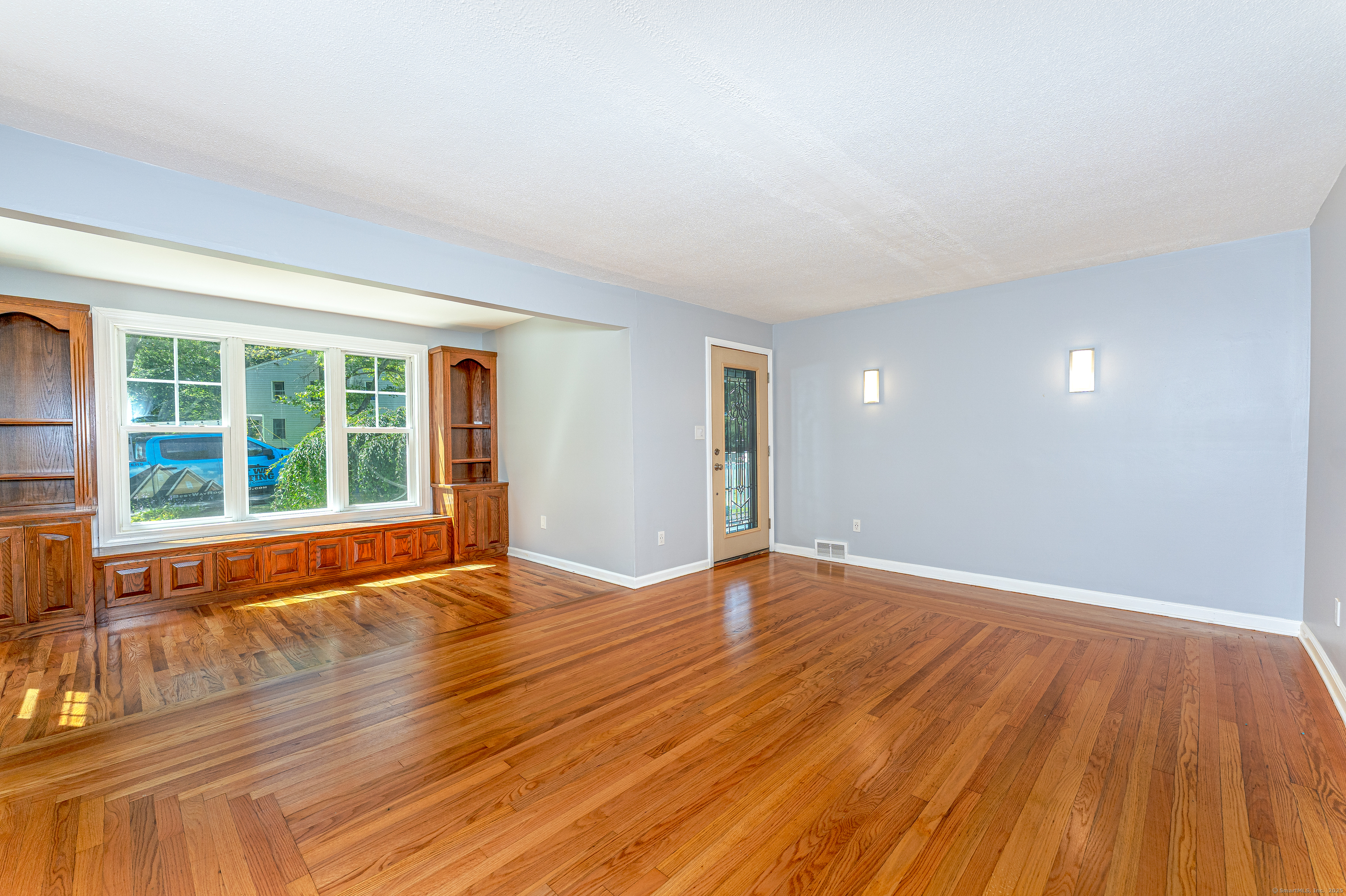 8 Ranslow Drive Wolcott, CT 06716 - Photo 8 of 31 a view of an empty room with wooden floor and a window