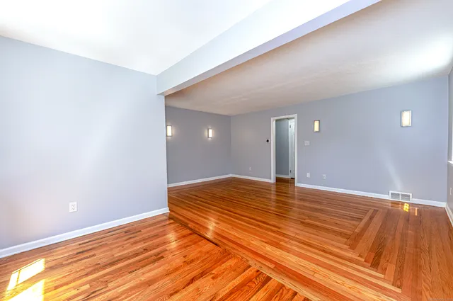 a view of a room with wooden floor