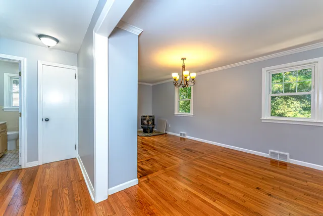 wooden floor in an empty room with a window