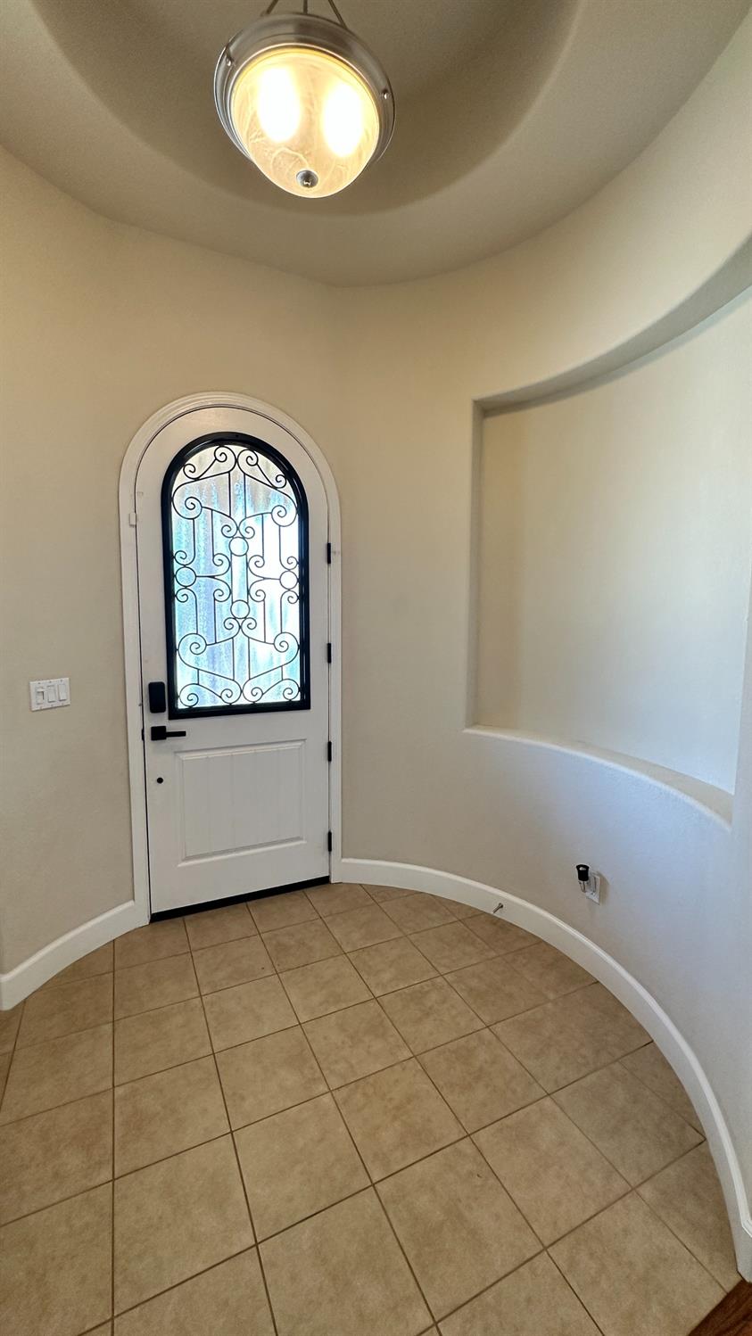 1040 Birch Run Way Manteca, CA 95336 - Photo 2 of 52 an empty room with a fireplace and windows
