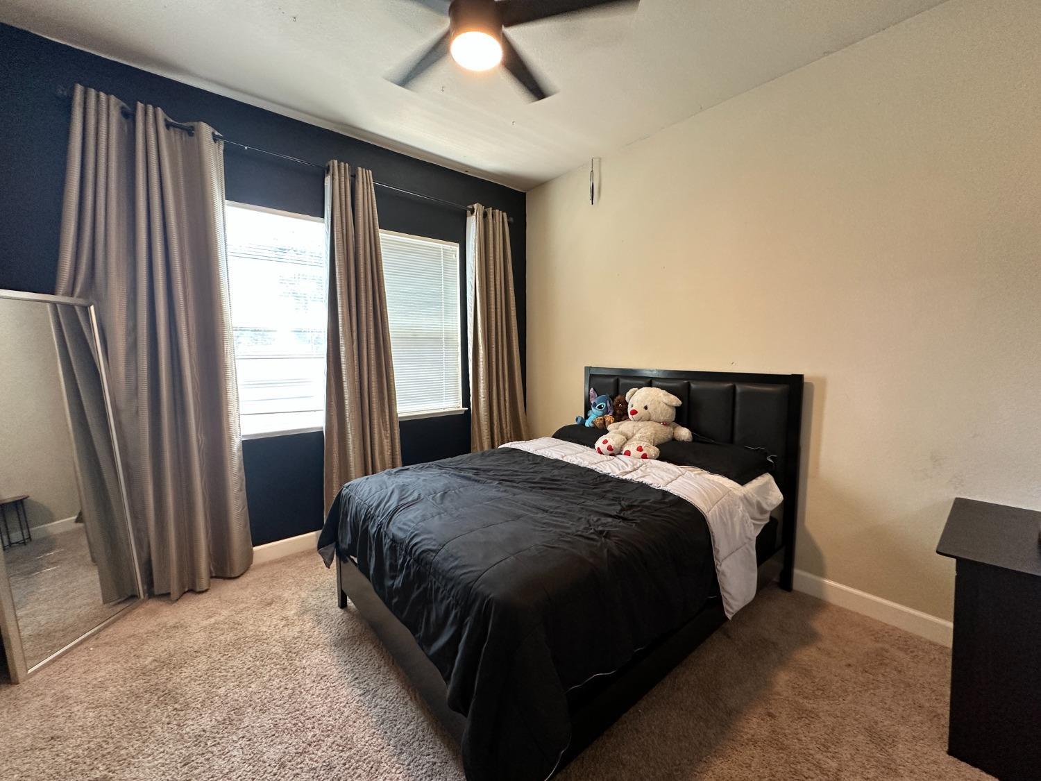 1040 Birch Run Way Manteca, CA 95336 - Photo 21 of 52 a bed sitting in a bedroom next to a window