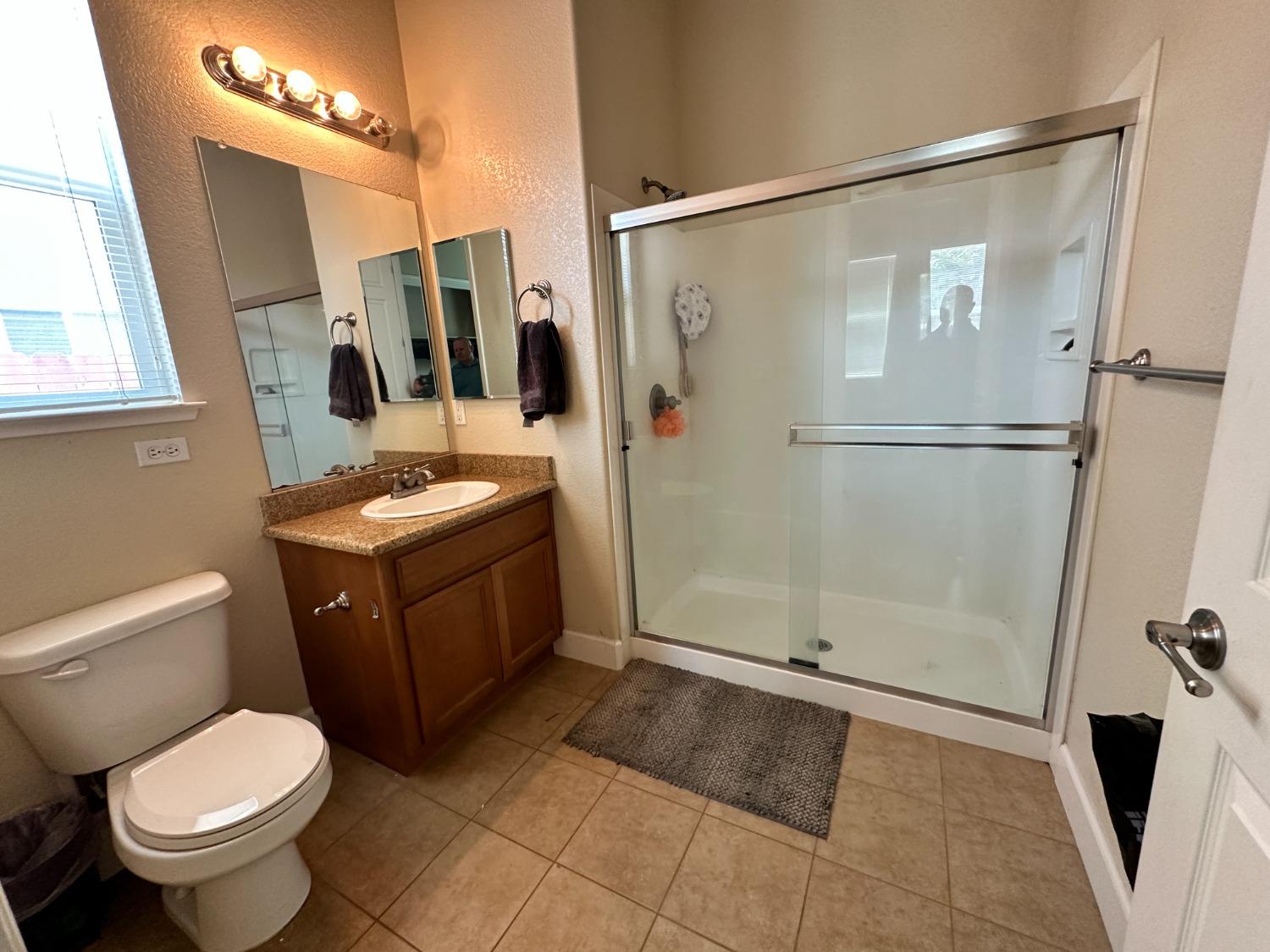 1040 Birch Run Way Manteca, CA 95336 - Photo 22 of 52 a bathroom with a granite countertop sink toilet and shower