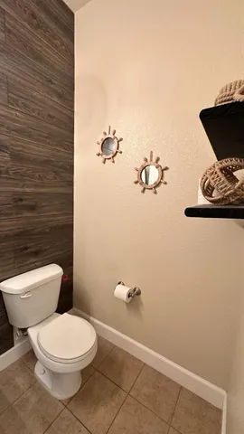 a view of an empty room with wooden floor and stairs