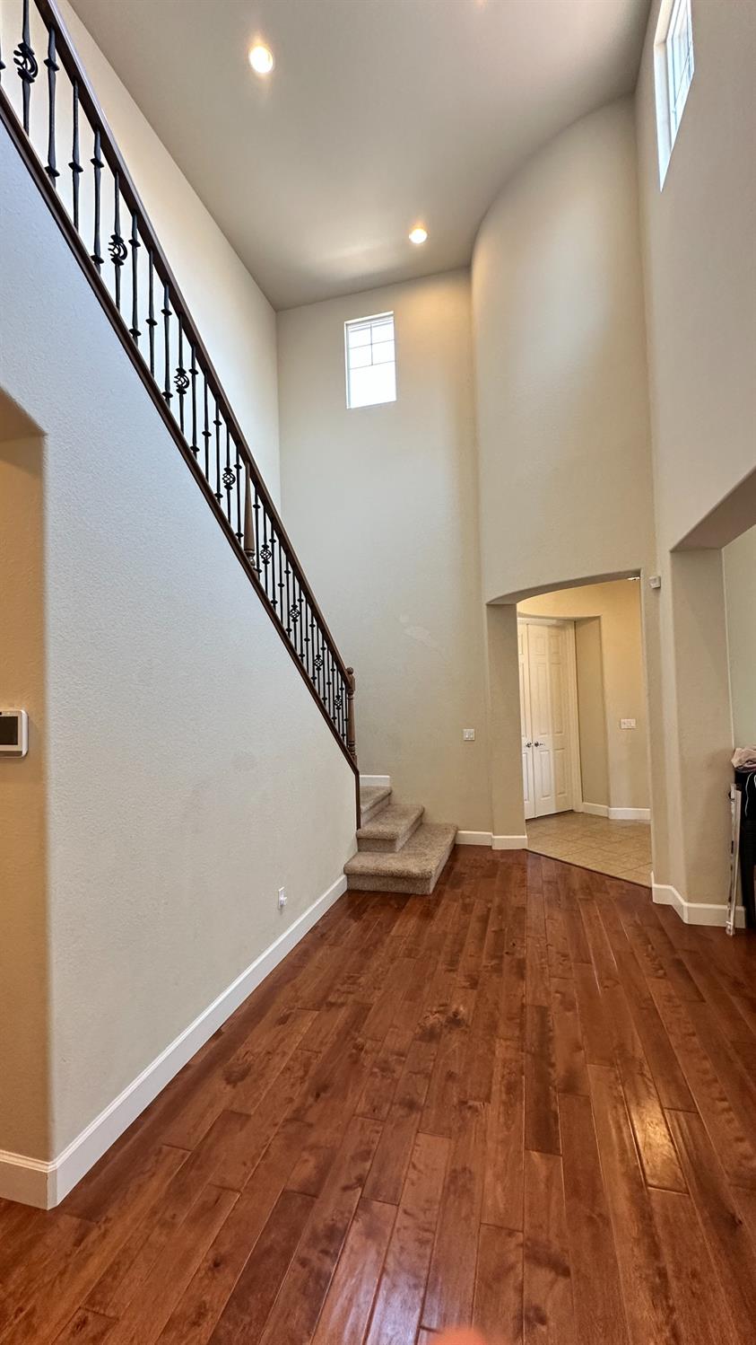 1040 Birch Run Way Manteca, CA 95336 - Photo 26 of 52 a view of an empty room with wooden floor and stairs