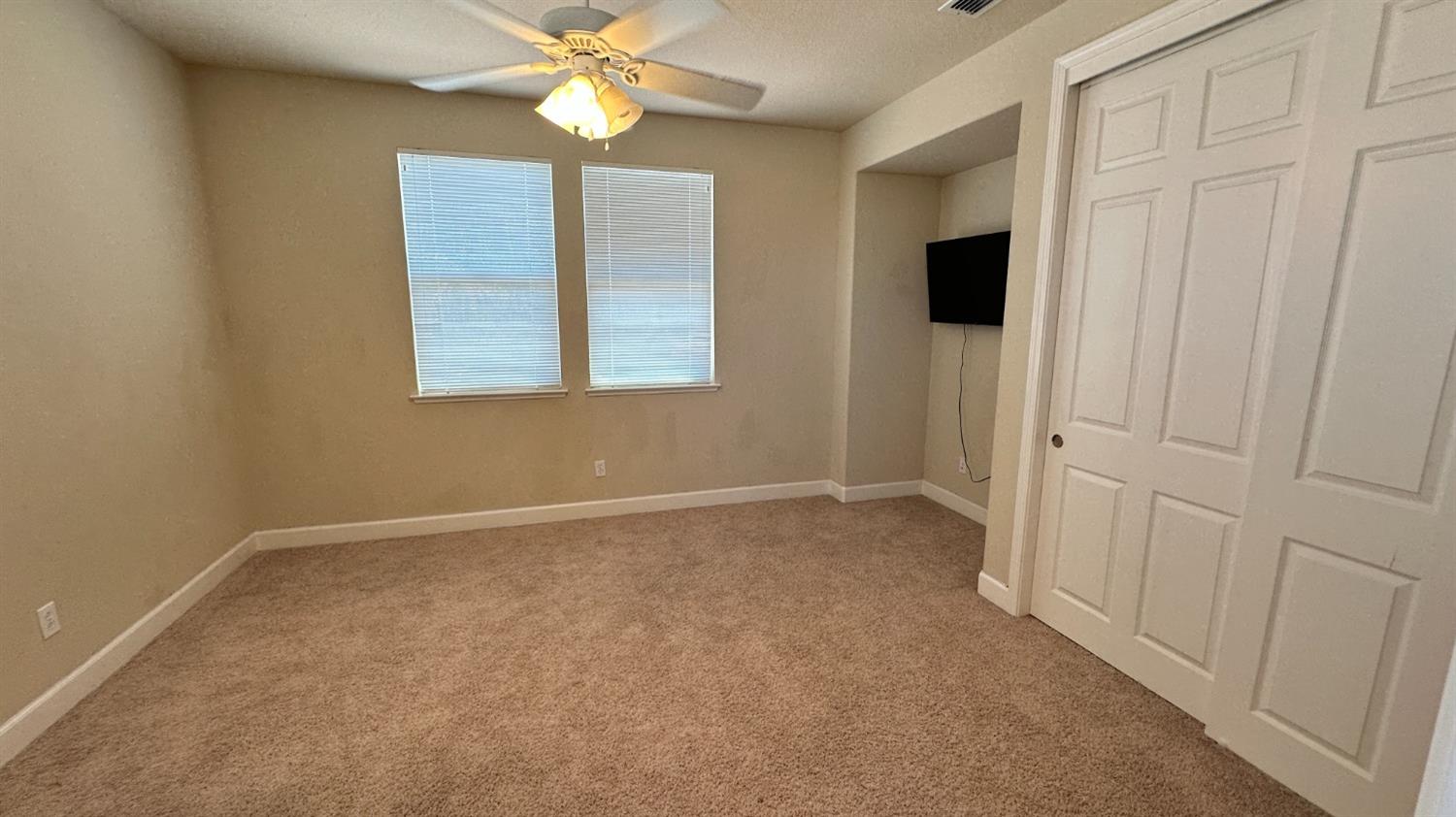 1040 Birch Run Way Manteca, CA 95336 - Photo 29 of 52 an empty room with windows and fan