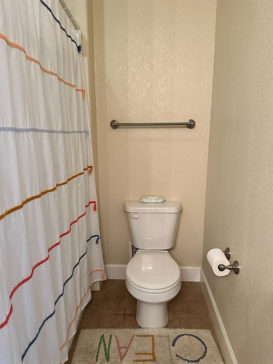 1040 Birch Run Way Manteca, CA 95336 - Photo 36 of 52 a bathroom with a toilet and a shower curtain