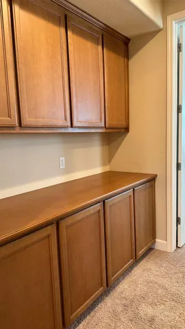 a kitchen with a sink a stove top oven and cabinets