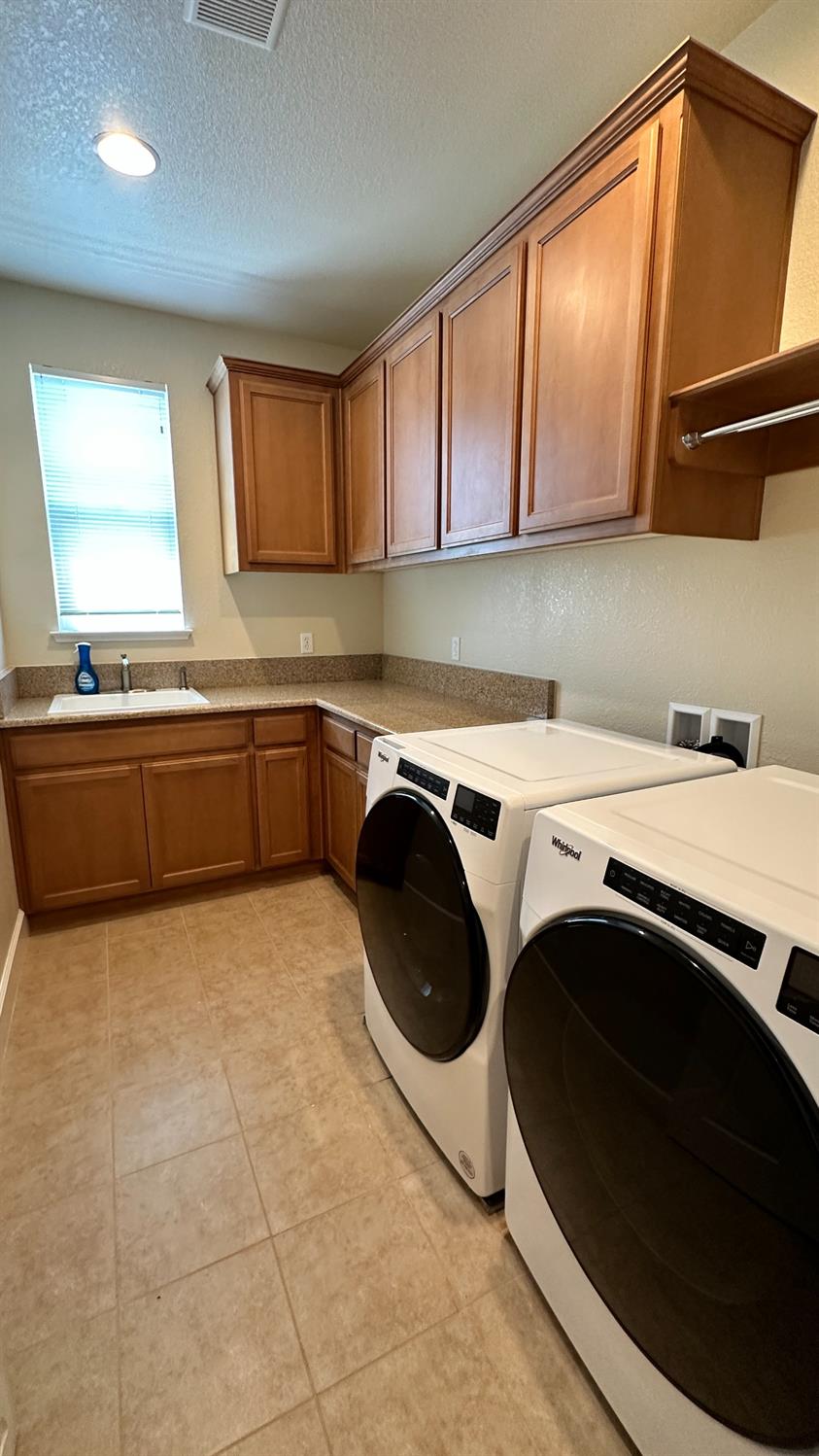 1040 Birch Run Way Manteca, CA 95336 - Photo 38 of 52 a kitchen with a sink a stove top oven and cabinets