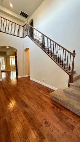a view of entryway hall and hall with wooden floor
