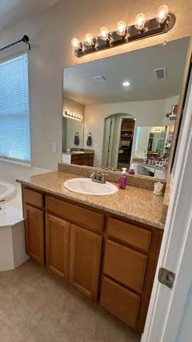 a bathroom with a bathtub and a sink