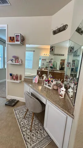 a view of walk in closet with clothes