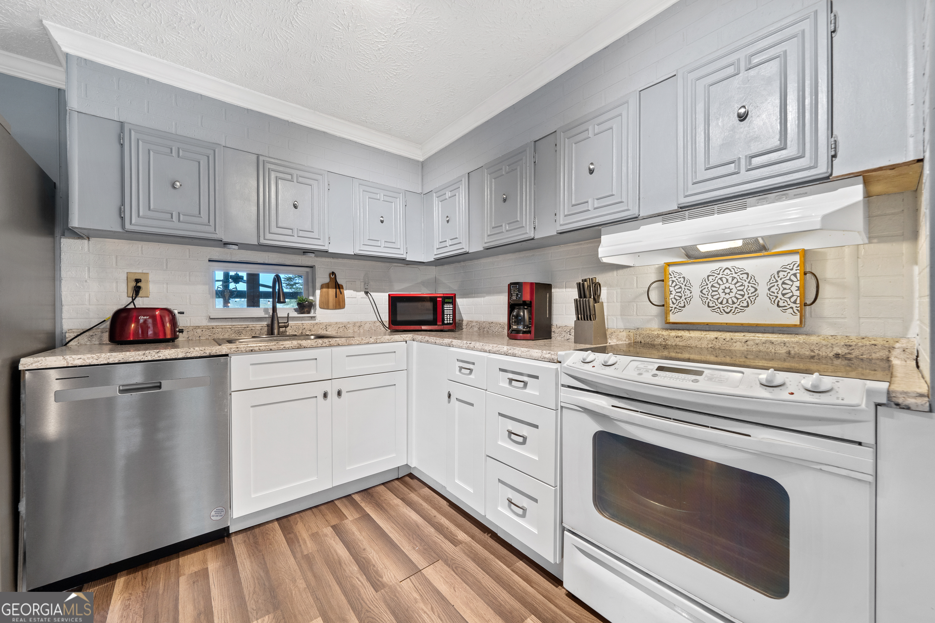 321 Barbara Point Road Sparta, GA 31087 - Photo 14 of 55 a kitchen with cabinets appliances a sink and a counter space