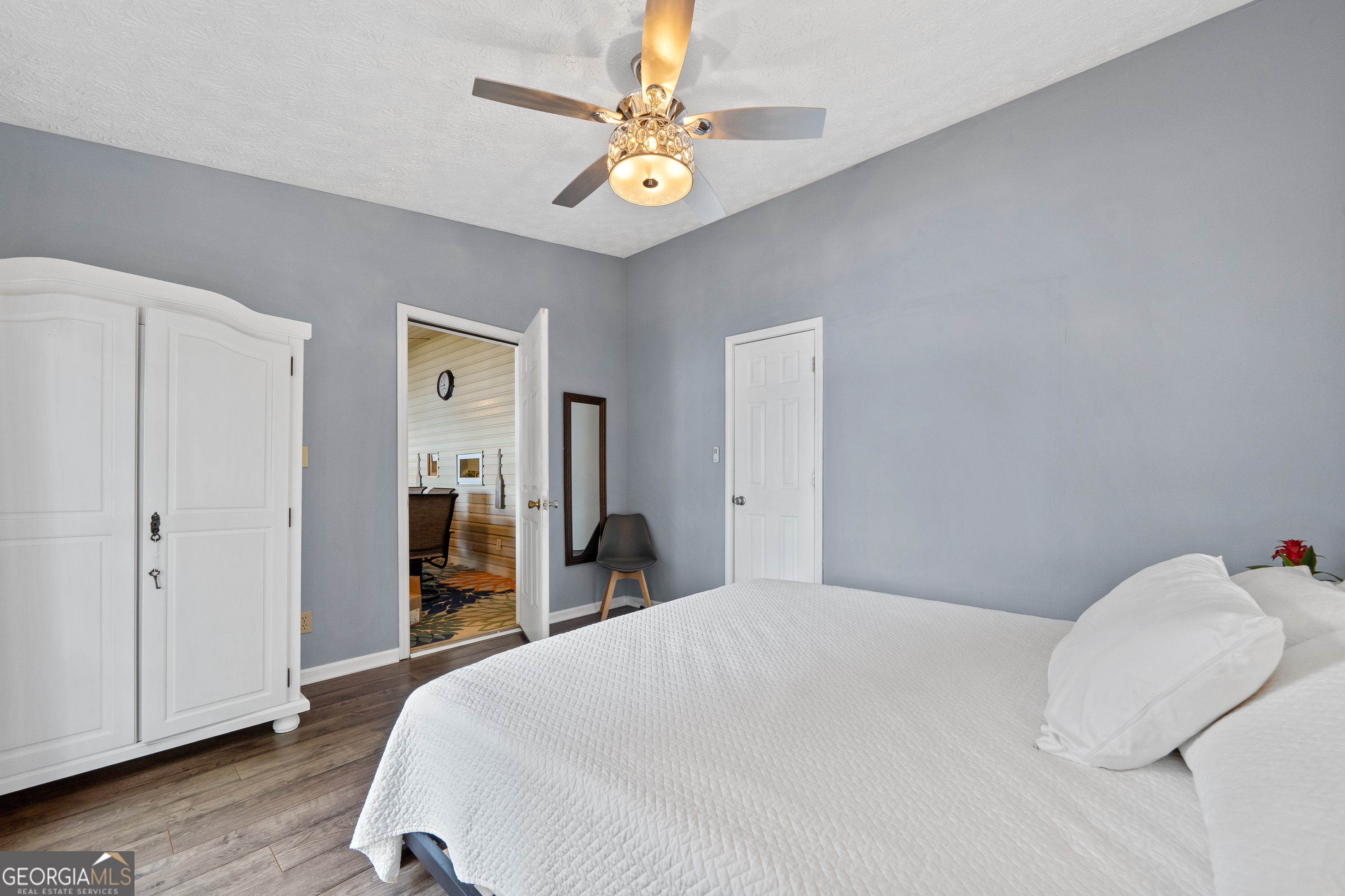 321 Barbara Point Road Sparta, GA 31087 - Photo 19 of 55 a bedroom with a bed and a chandelier