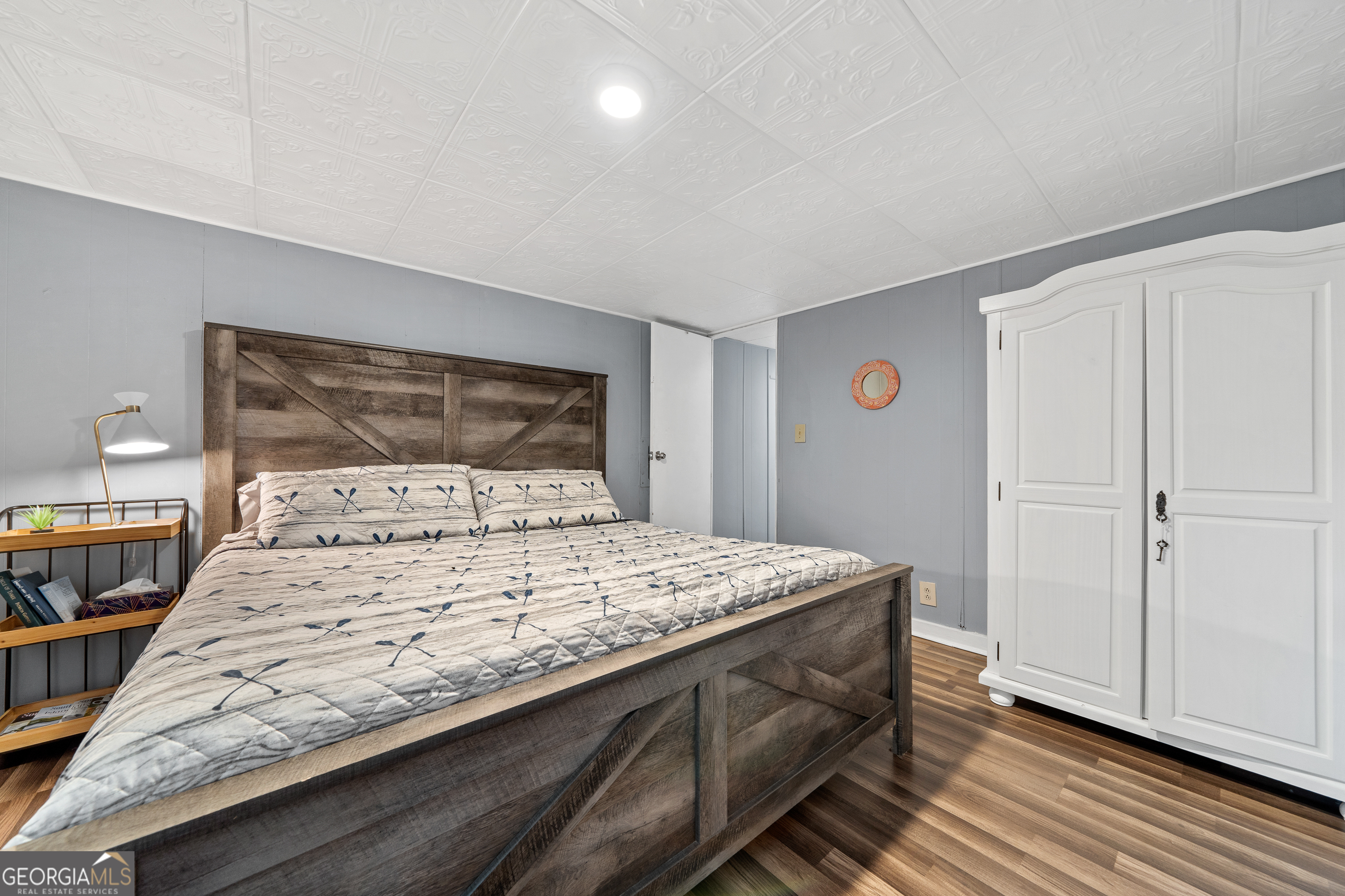 321 Barbara Point Road Sparta, GA 31087 - Photo 21 of 55 a bedroom with a bed and wooden floor