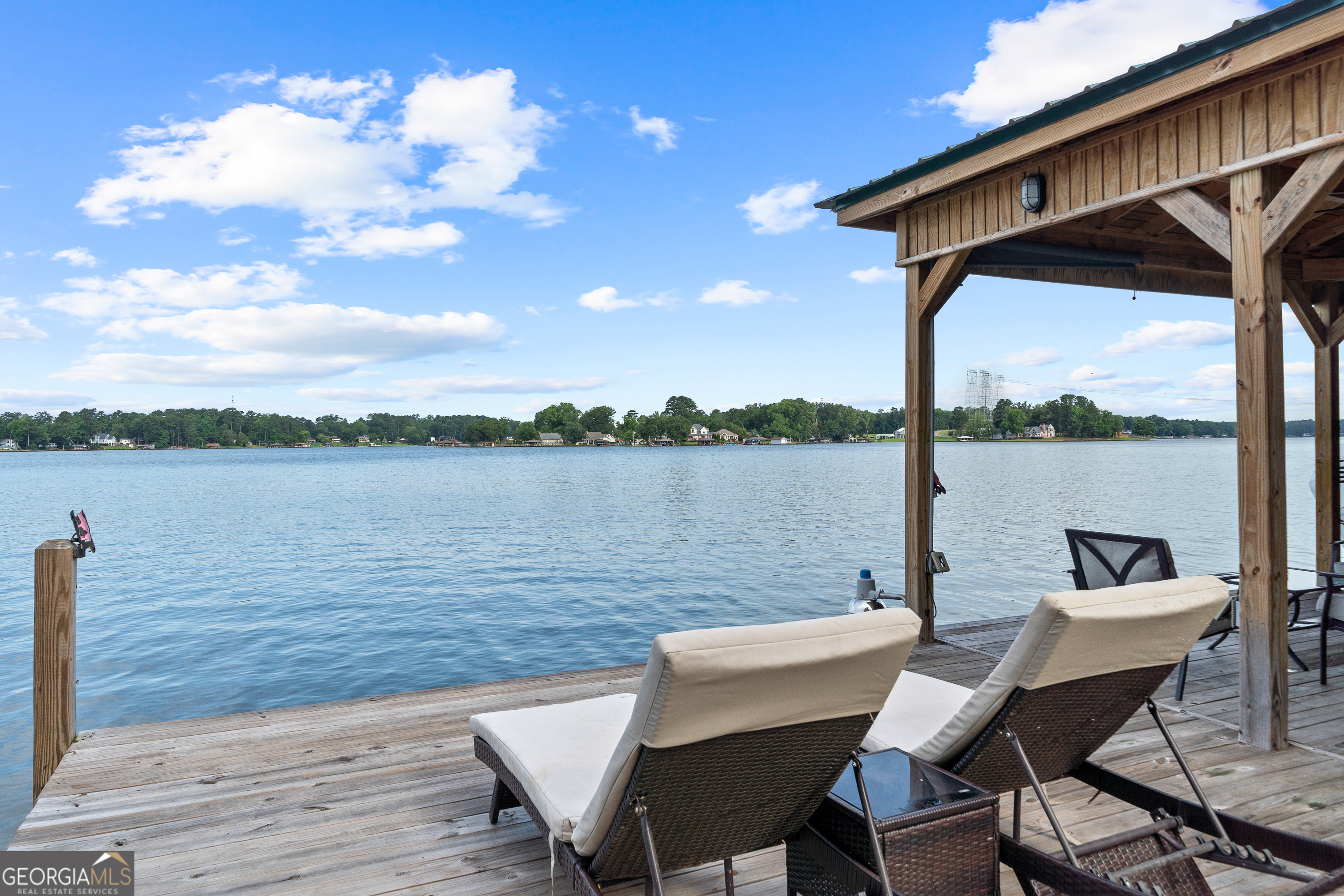 321 Barbara Point Road Sparta, GA 31087 - Photo 3 of 55 a view of a lake from a deck and a patio