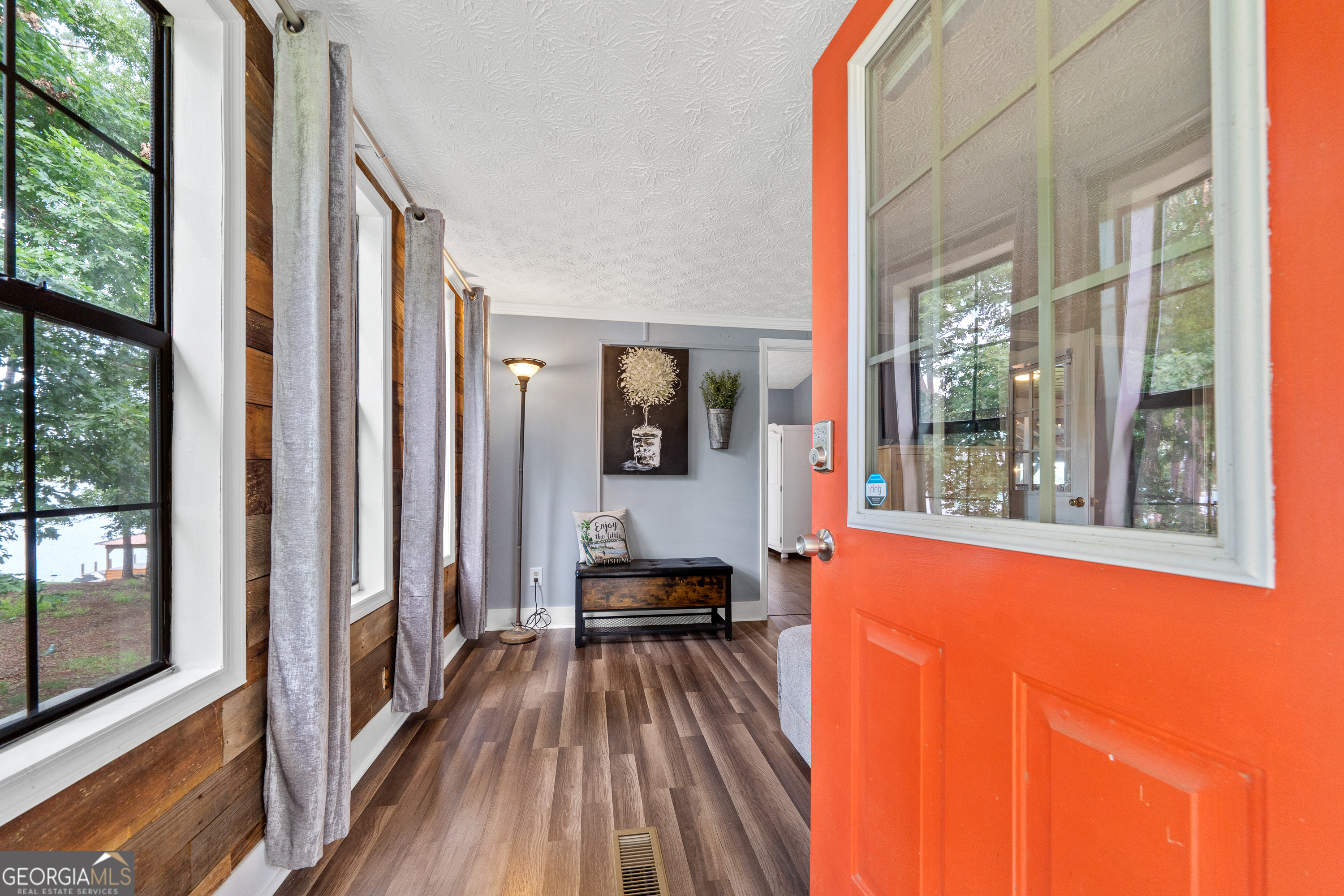 321 Barbara Point Road Sparta, GA 31087 - Photo 7 of 55 a hallway with a large window and wooden floor