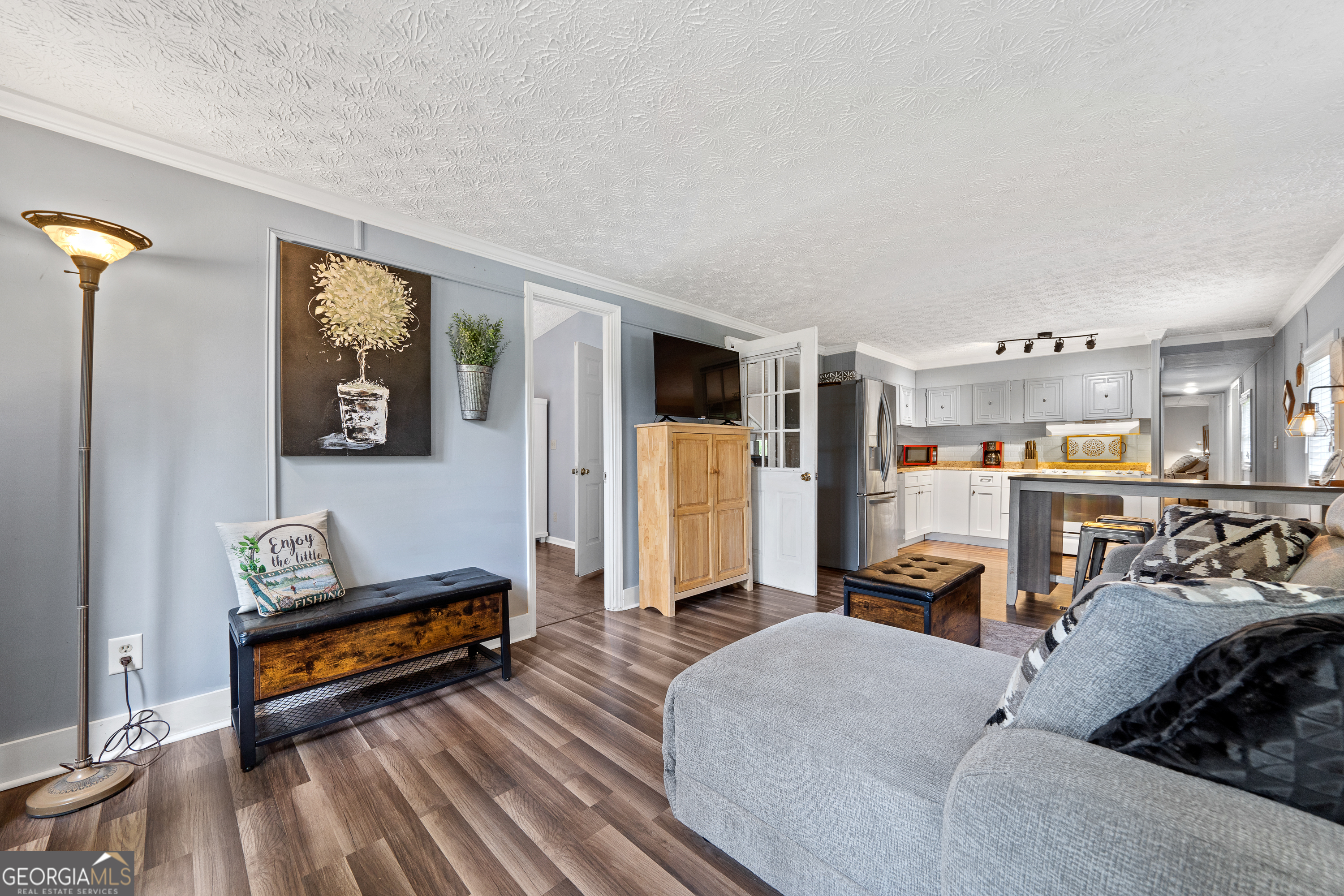321 Barbara Point Road Sparta, GA 31087 - Photo 9 of 55 a living room with furniture a rug and a wall painting
