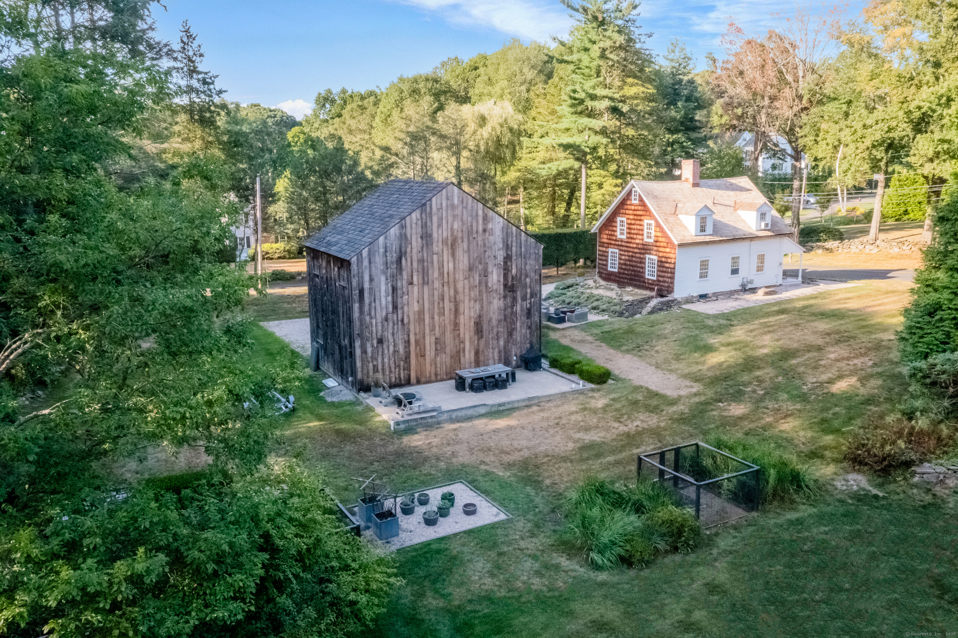 a view of a barn in the middle of a yard