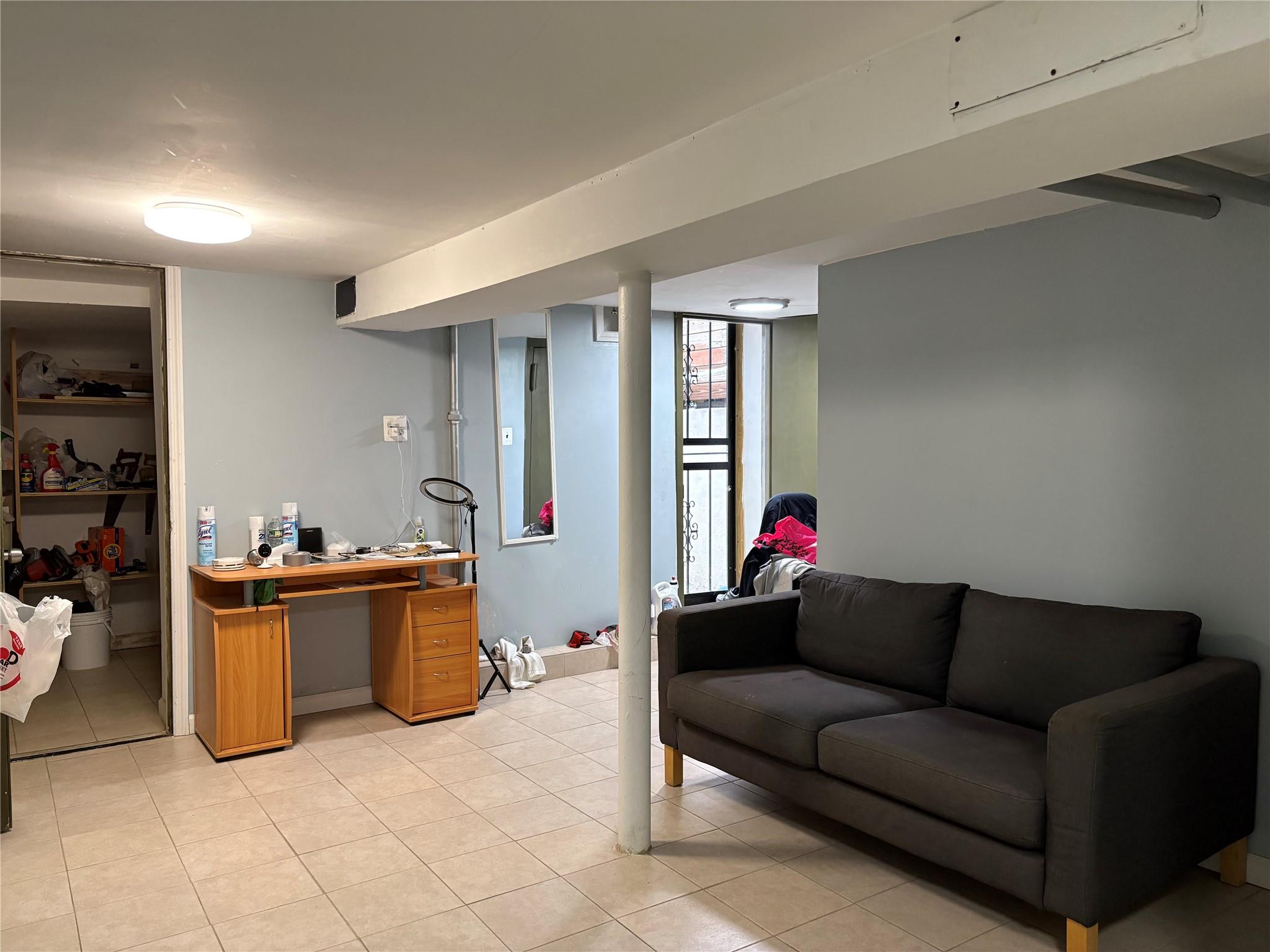 262 Grant Avenue Brooklyn, NY 11208 - Photo 13 of 14 a living room with furniture and a kitchen