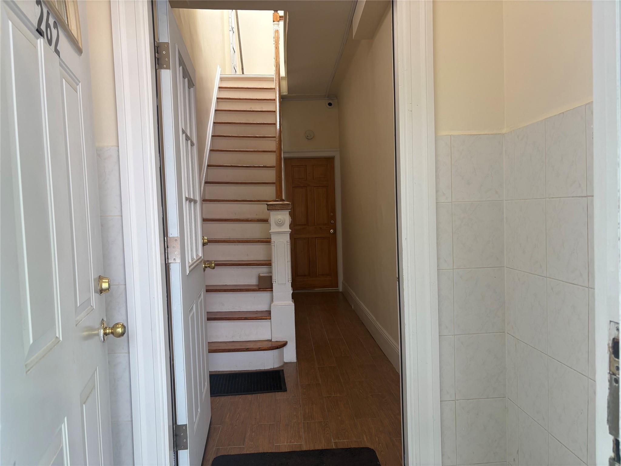 262 Grant Avenue Brooklyn, NY 11208 - Photo 9 of 14 a view of a hallway with stairs