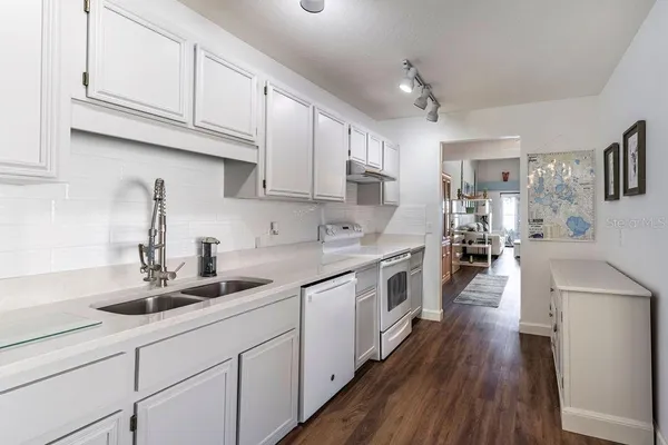 a kitchen with cabinets a sink and appliances