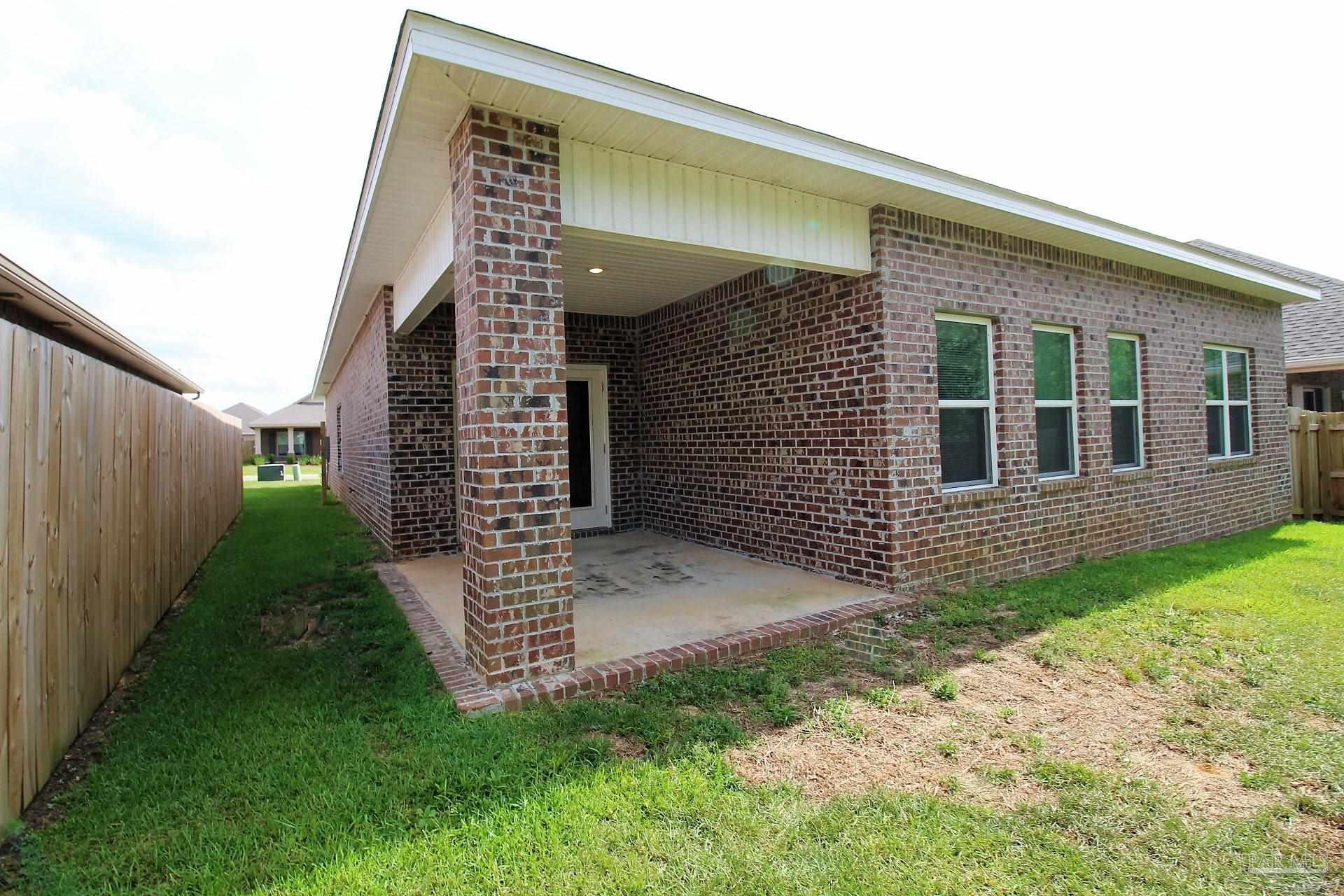 8006 Burnside Loop Pensacola, FL 32526 - Photo 21 of 22 a front view of a house with a garden