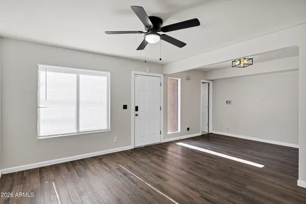 a kitchen with cabinets and wooden floor