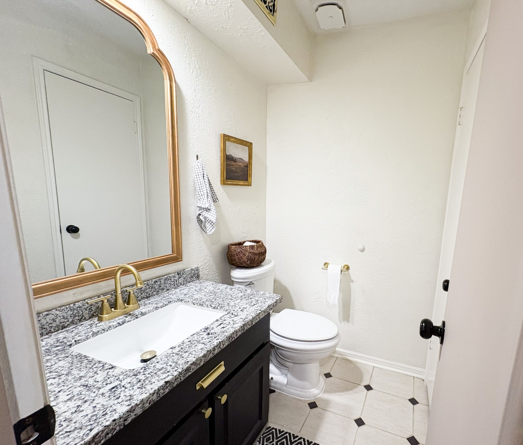 738 Thicket Lane Houston, TX 77079 - Photo 9 of 20 a bathroom with a granite countertop sink a toilet and a mirror