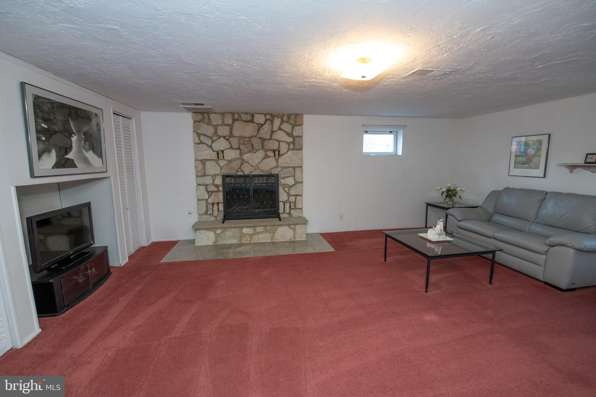 1836 Watson Road Abington, PA 19001 - Photo 14 of 22 a living room with furniture a flat screen tv and a fireplace