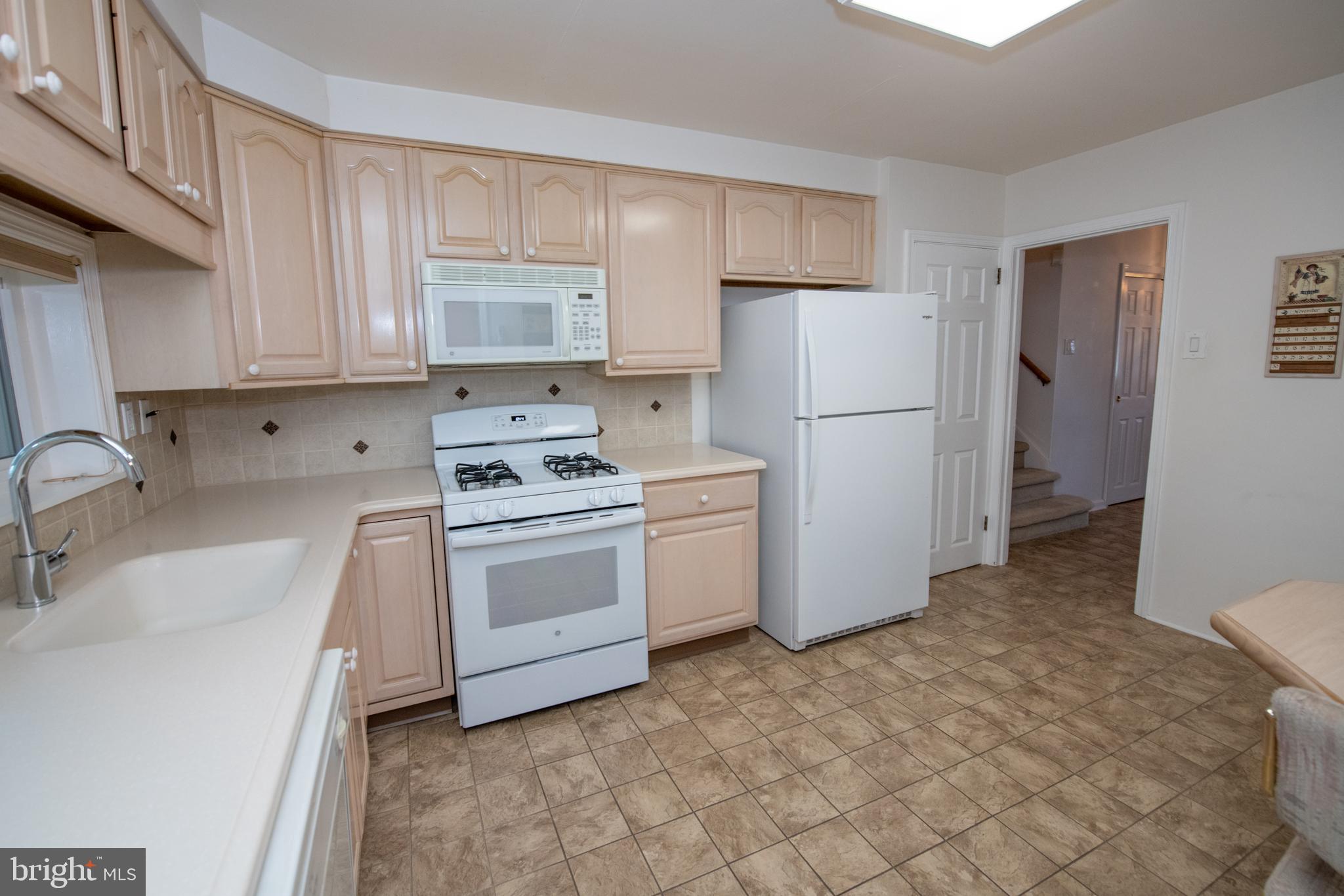 1836 Watson Road Abington, PA 19001 - Photo 6 of 22 a kitchen with a white stove refrigerator and cabinets
