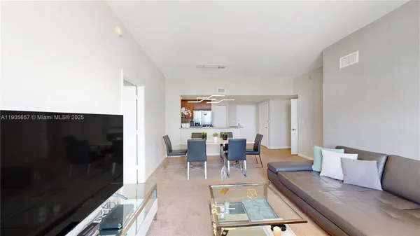 a living room with furniture rug and a fireplace