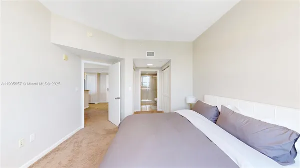 a bedroom with a bed and a painting