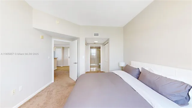 a bedroom with a bed and a painting