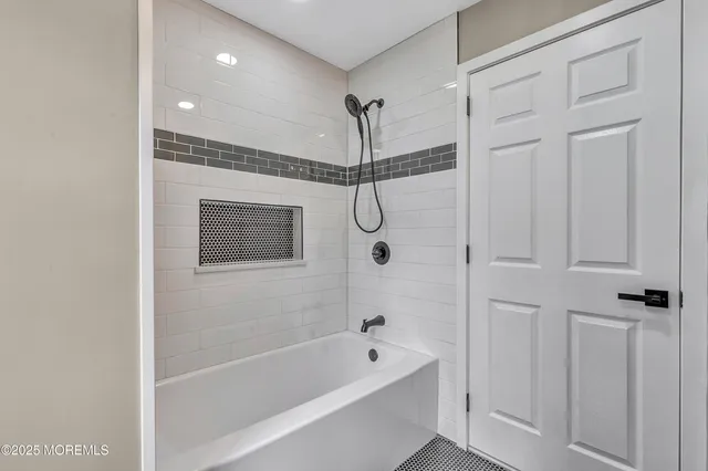 a bathroom with a bathtub and shower