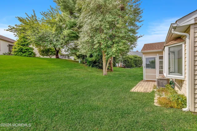 a front view of a house with a yard table and chairs