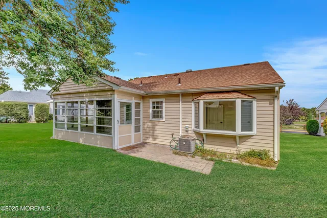 a view of a house with a yard and potted plants