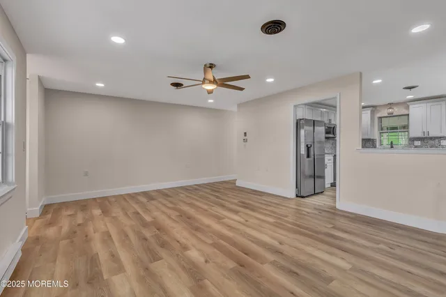 a view of an empty room with a ceiling fan
