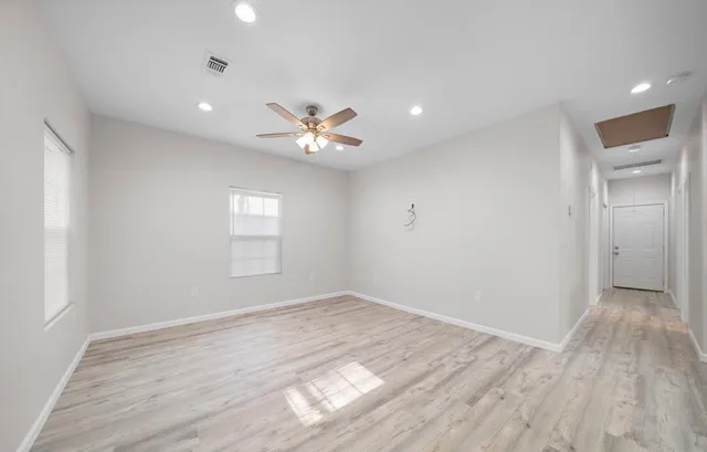 wooden floor in an empty room with a window