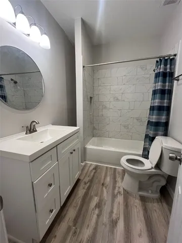 a bathroom with a double vanity sink toilet and shower