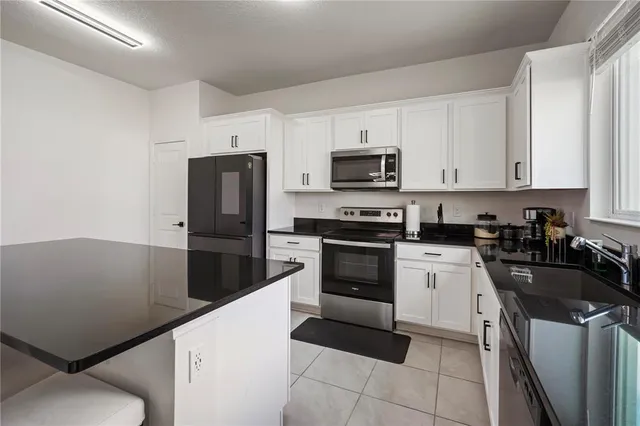 a kitchen with a sink appliances and cabinets