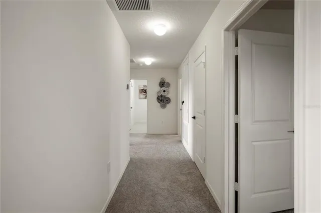 a view of a hallway with wooden shelves