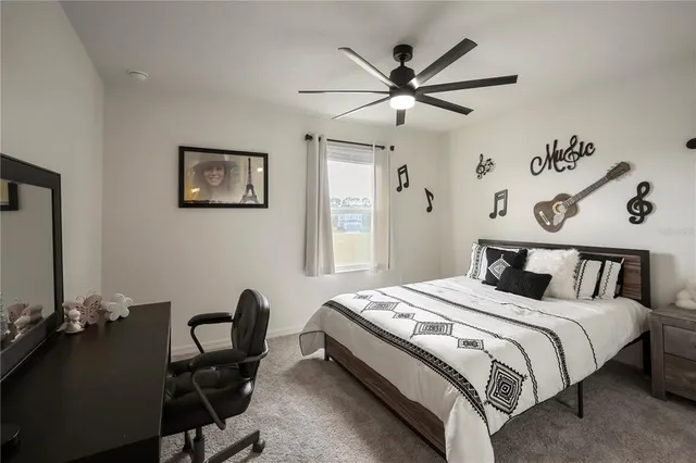 a bedroom with a bed and a desk